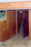 Facing towards the stairwell and rear door; washroom and coldroom are on the right, workroom on the left