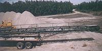 24' x 90' conveyor mounted on flat deck trailer.
